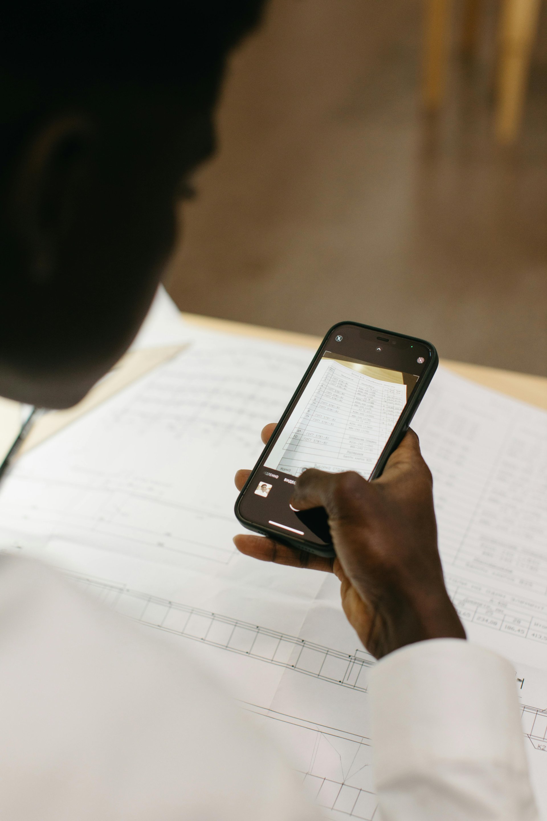 Person scanning document with smartphone