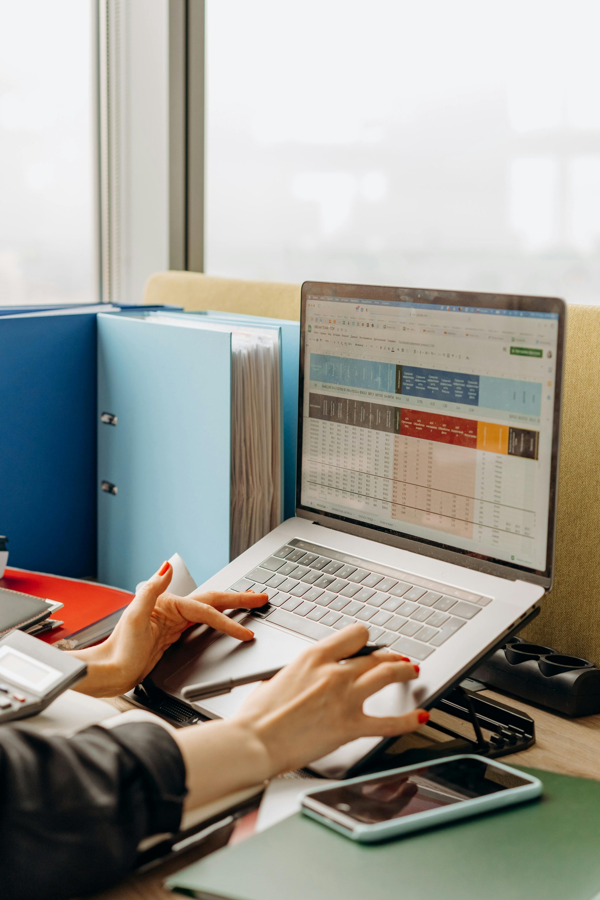Person working with spreadsheet data on laptop